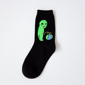 Black sock with a green alien urinating toward a small illustrated Earth, photographed flat on a pale background.
