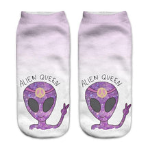 Pale lavender socks printed with purple alien heads, peace signs and the words Alien Queen, shown side by side.