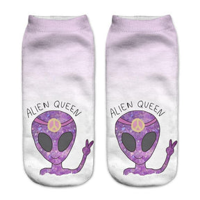 Pale lavender socks printed with purple alien heads, peace signs and the words Alien Queen, shown side by side.
