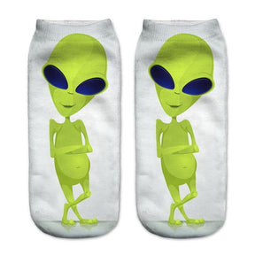 White socks with a full-length lime-green alien standing with folded arms and crossed legs.