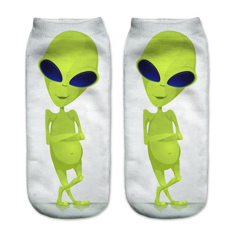 White socks with a full-length lime-green alien standing with folded arms and crossed legs.