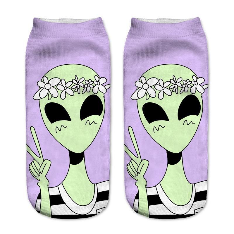 Lavender socks with a smiling green alien wearing a white flower crown and holding up a peace sign.