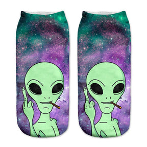 Purple and green galaxy-print socks with a green alien holding a cigarette and raising a middle finger.