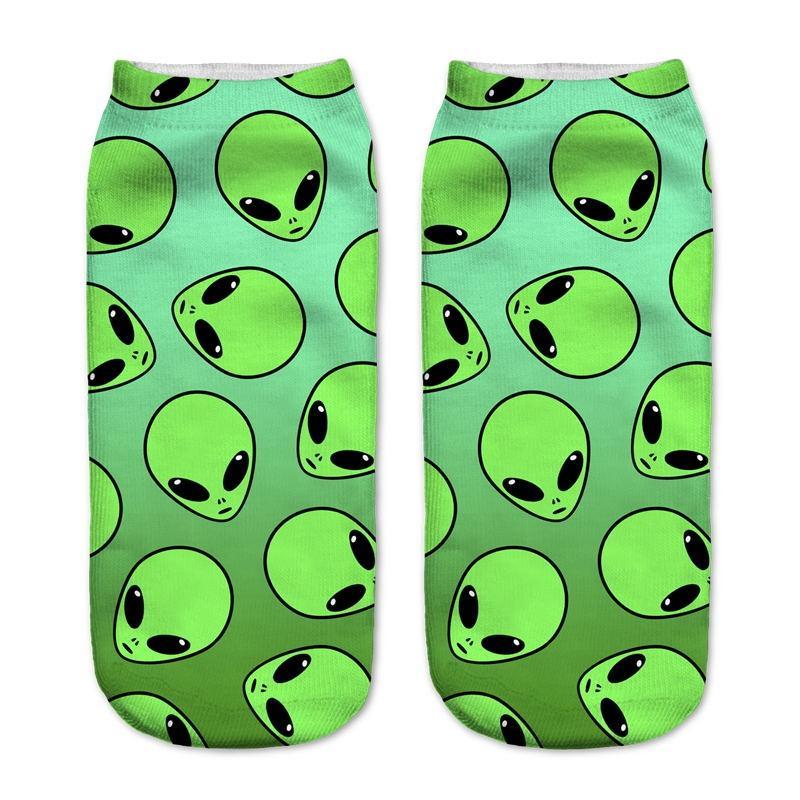 Bright green socks with an all-over pattern of black-eyed alien faces.