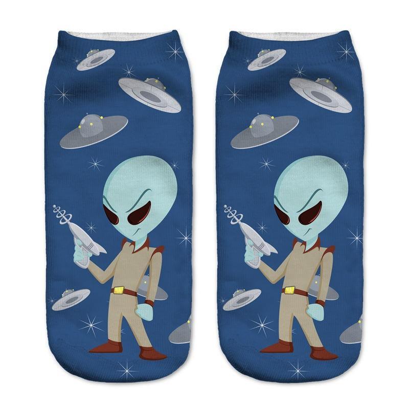 Navy socks showing a blue-headed alien character with a ray gun, surrounded by small UFOs and stars.