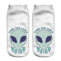 White socks with a pale green alien face and the words Wish You Were Weird in blue lettering.