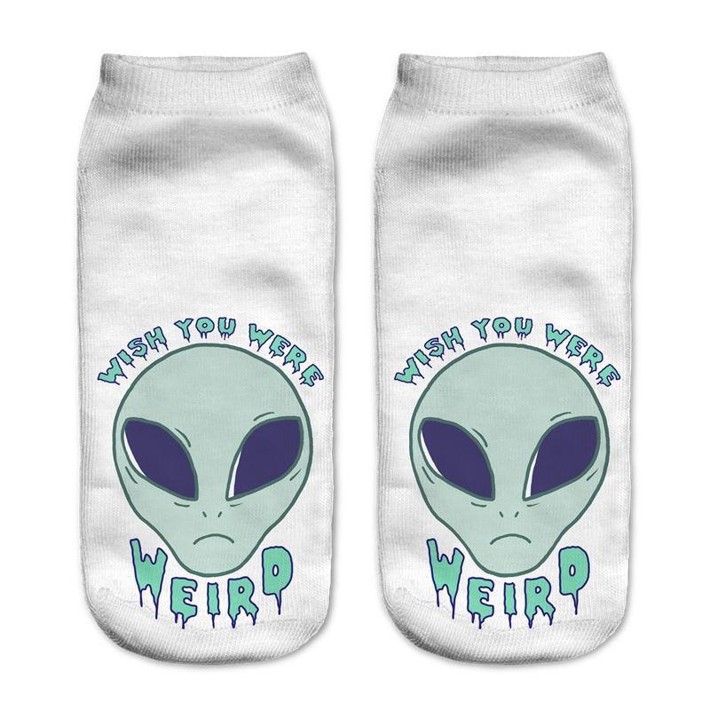 White socks with a pale green alien face and the words Wish You Were Weird in blue lettering.