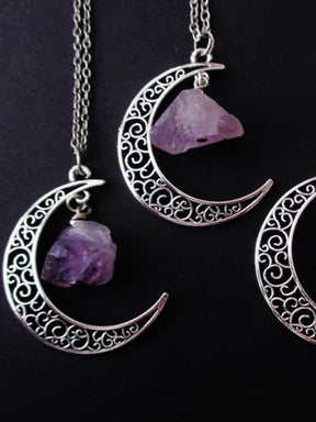 Amethyst crescent moon necklace in the Filigree Crescent design, shown in a close group on black.