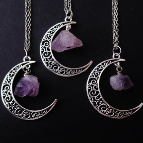 Amethyst crescent moon necklace in the Filigree Crescent design with three pendants and chains on black.