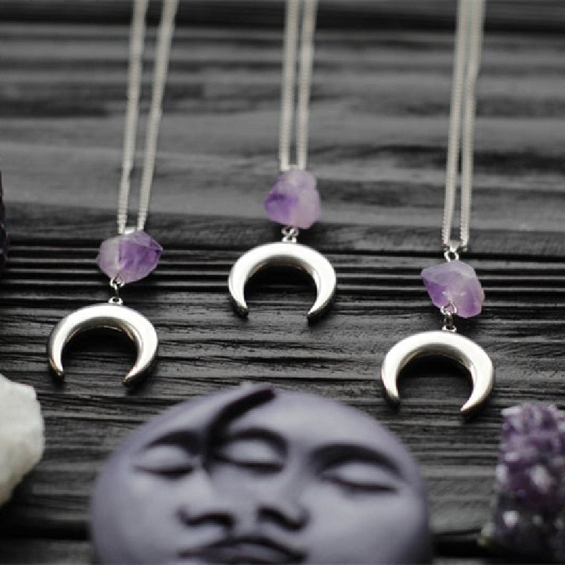 Amethyst crescent moon necklace in the Smooth Crescent design, showing variations in the purple crystals.