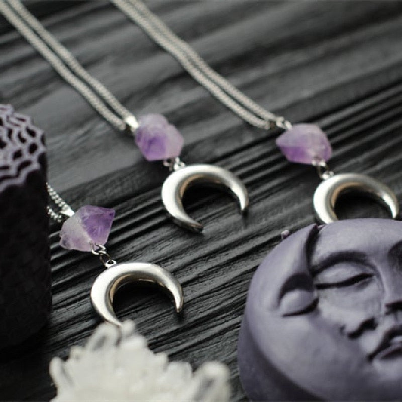 Amethyst crescent moon necklace in the Smooth Crescent design, arranged diagonally.