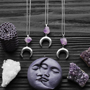 Amethyst crescent moon necklace in the Smooth Crescent design with full chains and decorative crystal props.