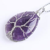 Purple amethyst Tree of Life necklace with silver-tone branches, a wrapped bail and a fine chain.