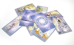 A scattered spread of fantasy tarot cards, with detailed figures, branches and varied pastel-toned scenes.