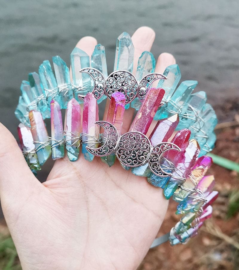 Aqua and bright rainbow crystal crowns held together, comparing blue-green points with a vivid multicoloured arrangement.