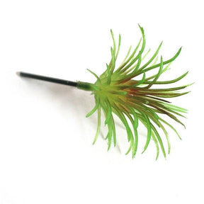Green artificial succulent with fine pointed leaves forming a bushy head.