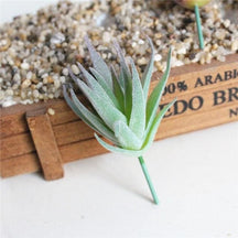 Artificial succulent stem with dense narrow green leaves radiating around the branch.