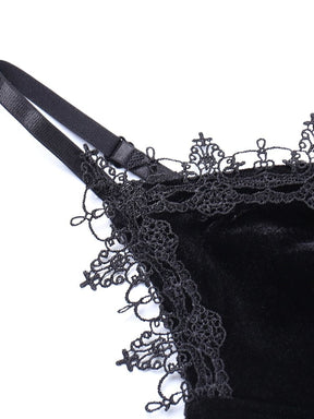 Close-up of the black shoulder strap slider beside the intricate lace neckline trim on the velour dress.