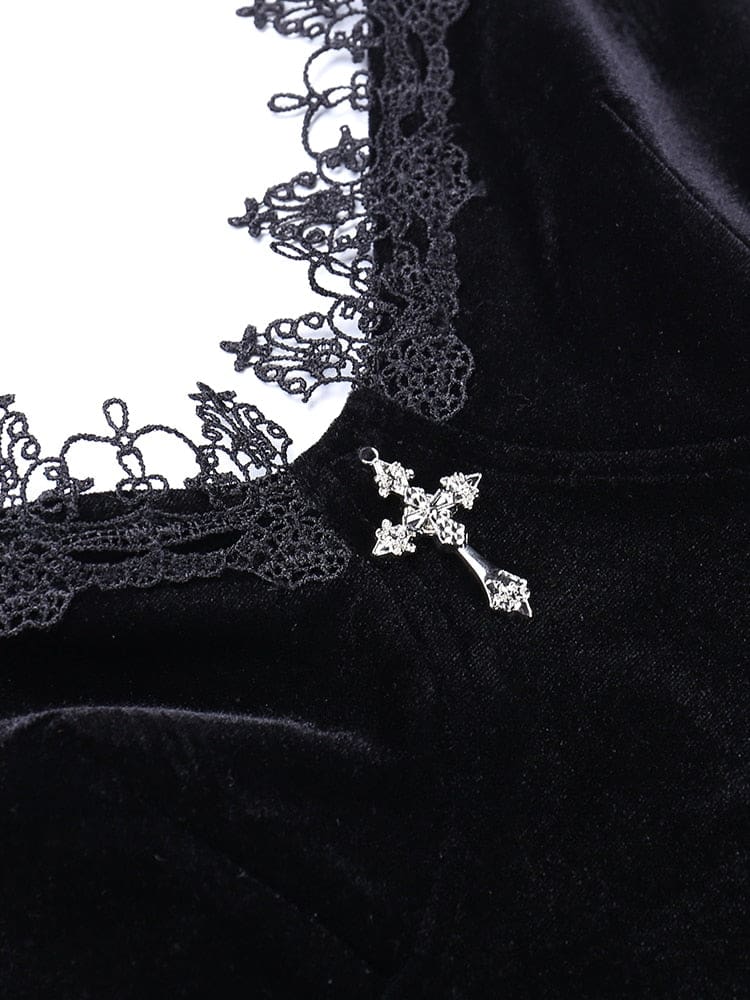 Silver-tone cross detail at the center of the black velour dress neckline, bordered by looped floral lace.