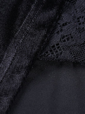 Macro view of the junction between black velour, sheer mesh and floral lace in the dress construction.