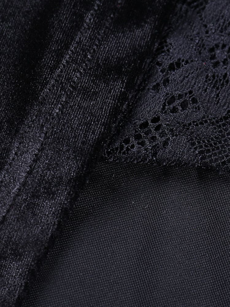 Macro view of the junction between black velour, sheer mesh and floral lace in the dress construction.