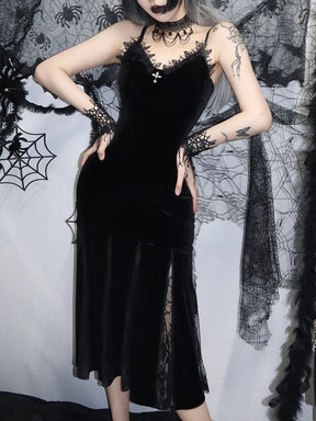 Black gothic velour dress shown with both hands at the waist, highlighting the fitted body and flared lace-insert skirt.