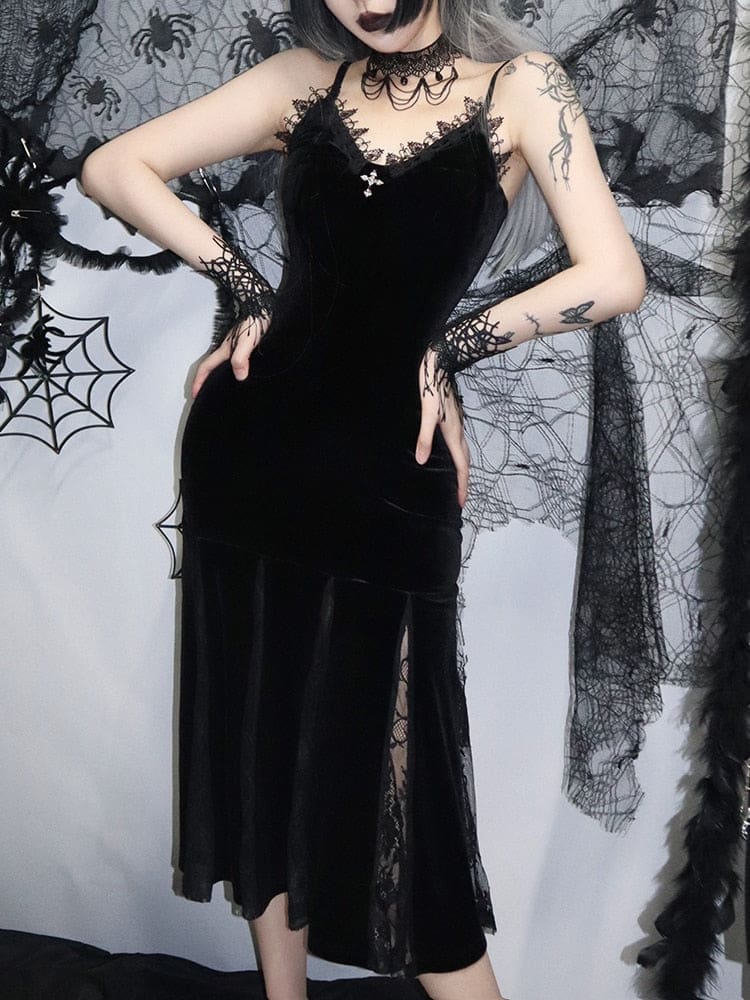 Black gothic velour dress shown with both hands at the waist, highlighting the fitted body and flared lace-insert skirt.