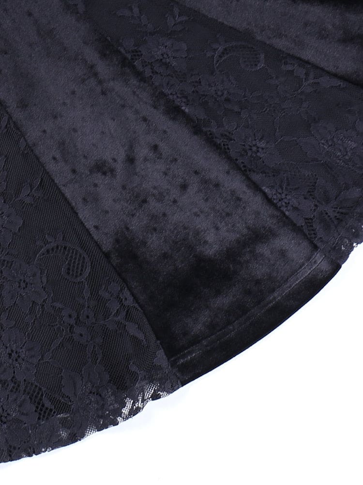 Close-up of alternating black velour and sheer floral lace panels at the dress hem.