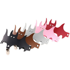 A group of bat-shaped garters in dark, bright and pastel colours, each with a matching band and stocking clip.