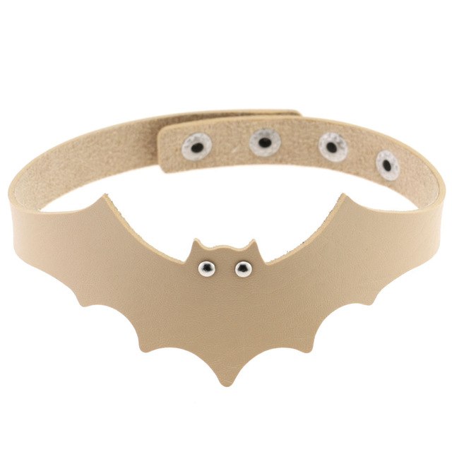 Beige faux leather bat wing choker shown fastened in a circle, with a scalloped front, pointed ears and two silver-tone eyelet eyes. The adjustable snap positions are visible across the back.