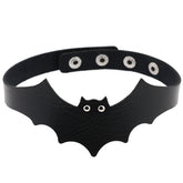 Black faux leather bat wing choker shown fastened in a circle, with a scalloped front, pointed ears and two silver-tone eyelet eyes. The adjustable snap positions are visible across the back.