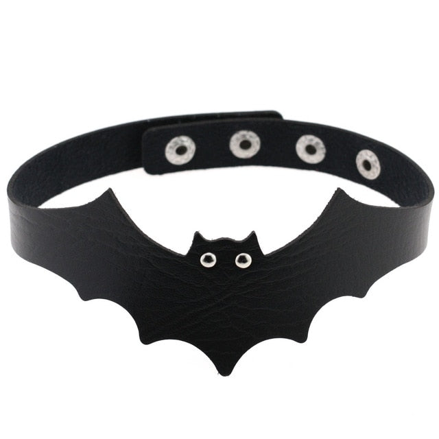 Black faux leather bat wing choker shown fastened in a circle, with a scalloped front, pointed ears and two silver-tone eyelet eyes. The adjustable snap positions are visible across the back.