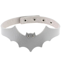 Silver faux leather bat wing choker shown fastened in a circle, with a scalloped front, pointed ears and two silver-tone eyelet eyes. The adjustable snap positions are visible across the back.