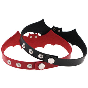 Rear view of black and red bat wing chokers, showing the press studs and multiple fastening positions. The bat-shaped fronts curve around behind the closures.