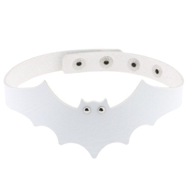 White faux leather bat wing choker shown fastened in a circle, with a scalloped front, pointed ears and two silver-tone eyelet eyes. The adjustable snap positions are visible across the back.