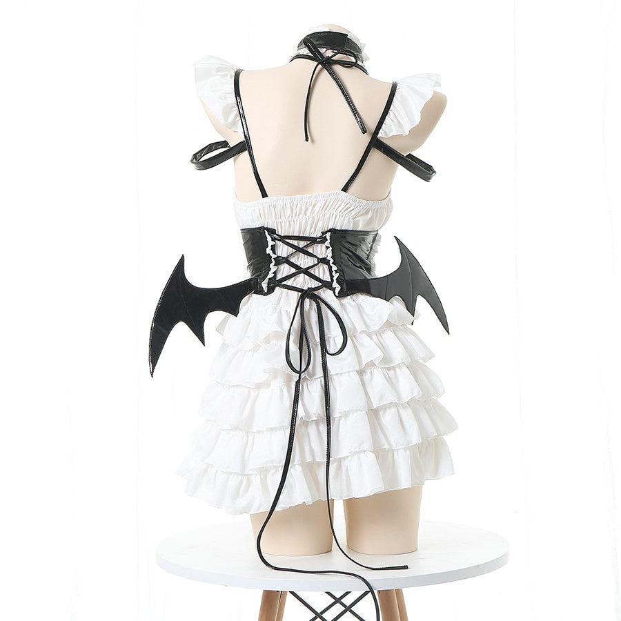 Bat-wing maid costume with a structured bodice, white ruffled skirt and crisscross back, available in black or pink.