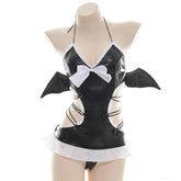 Front mannequin view of black bat wing lingerie with a white bow, pale neckline trim and ruffled lower edge.