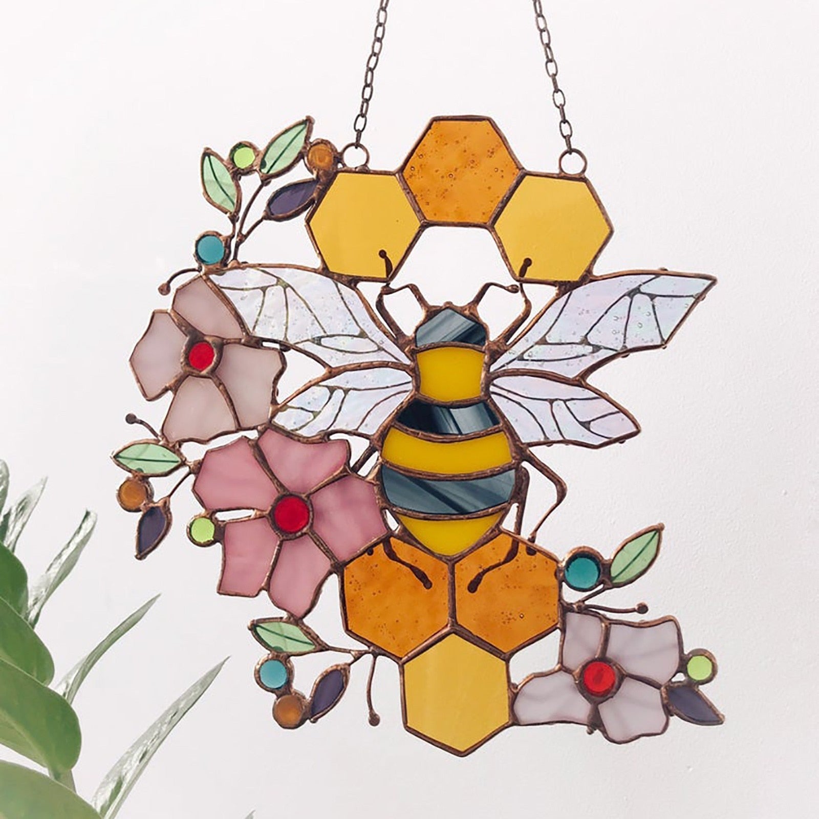 Bee and honeycomb stained glass hanging showing the reverse of the large floral bee design.