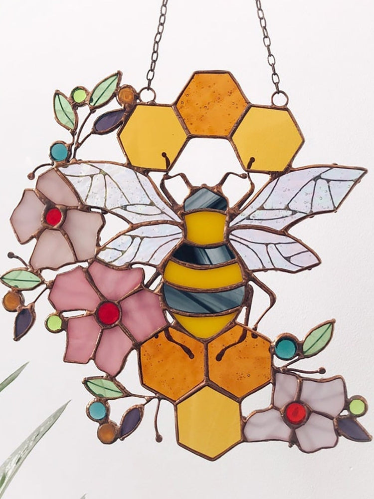 Bee and honeycomb stained glass hanging shown from the opposite side with its floral bee design.