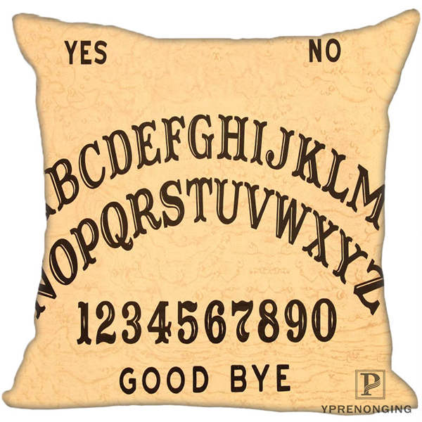 Beige square spirit-board cushion cover with curved black alphabet rows, numbers, Yes and No at the top and Good Bye below.