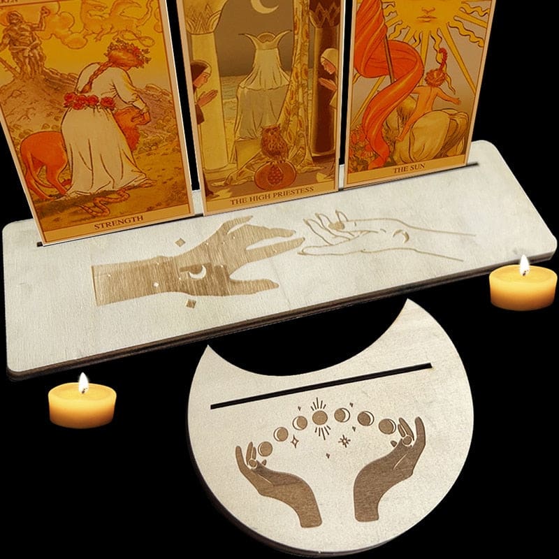 Reaching-hand artwork across a beige rectangular card holder and matching moon piece, with the narrow card slots visible.