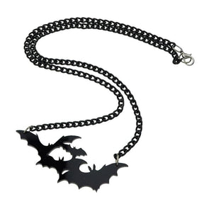 Black bat silhouette necklace laid out on white, showing the full chain, clasp and wide wing-shaped pendant.