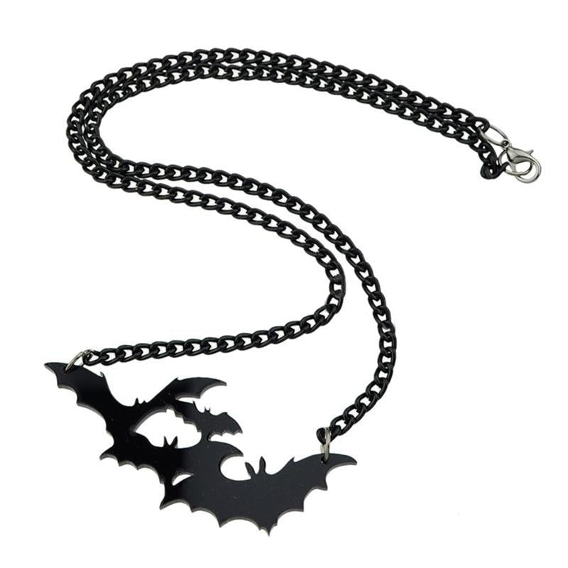 Black bat silhouette necklace laid out on white, showing the full chain, clasp and wide wing-shaped pendant.