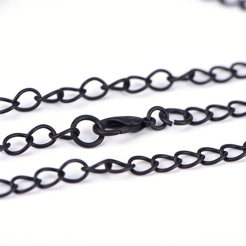 Close-up of the black necklace chain, lobster clasp and extension links on a white background.
