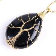 Black agate pendant on a gold-tone chain, with fine gold-tone wire branches contrasting against the dark stone.