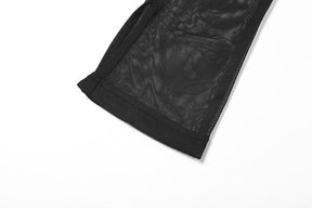 Detail of a black mesh bell sleeve laid flat, showing the transparent fabric and stitched edge at the flared cuff.