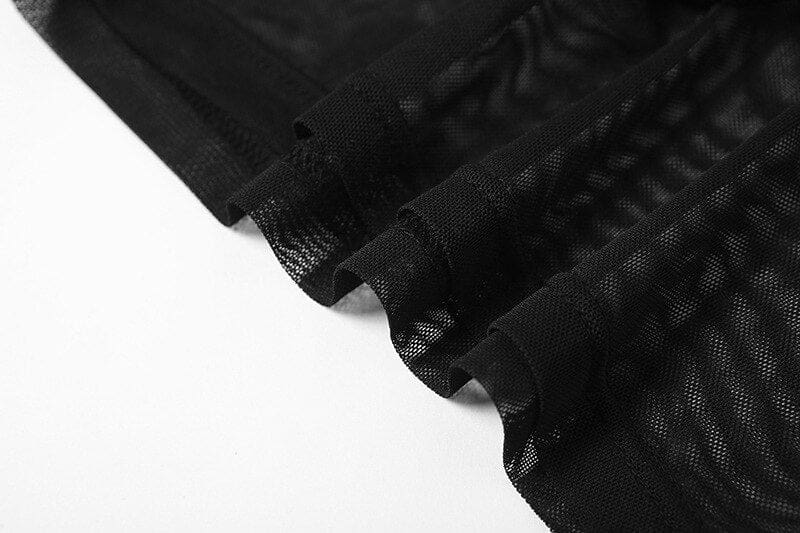Close-up of the black mesh fabric and finished seams on the crop top and sleeve set, with the transparent material folded over a white background.