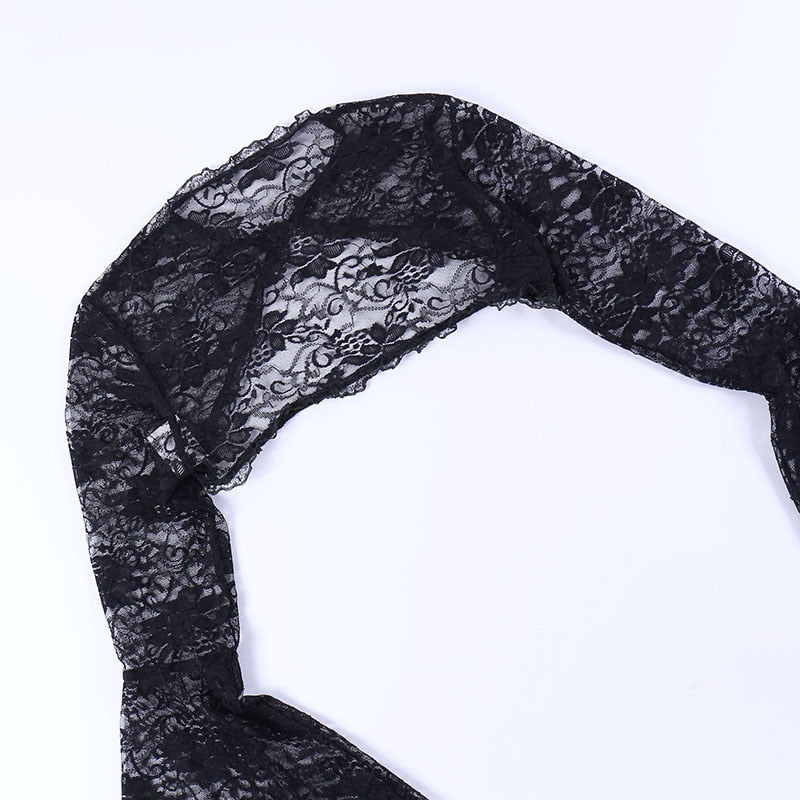 Black lace overlay laid flat to show its cropped back panel, floral pattern and shoulder seams.