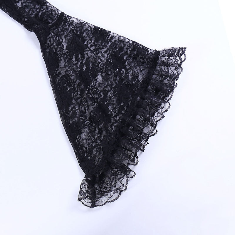 Close view of the overlay's black bell sleeve spreading into a wide ruffled floral-lace cuff.