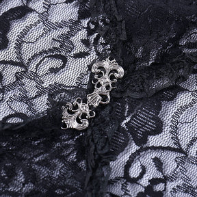Macro view of the decorative silver-tone clasp joining the black floral lace bolero at the front.